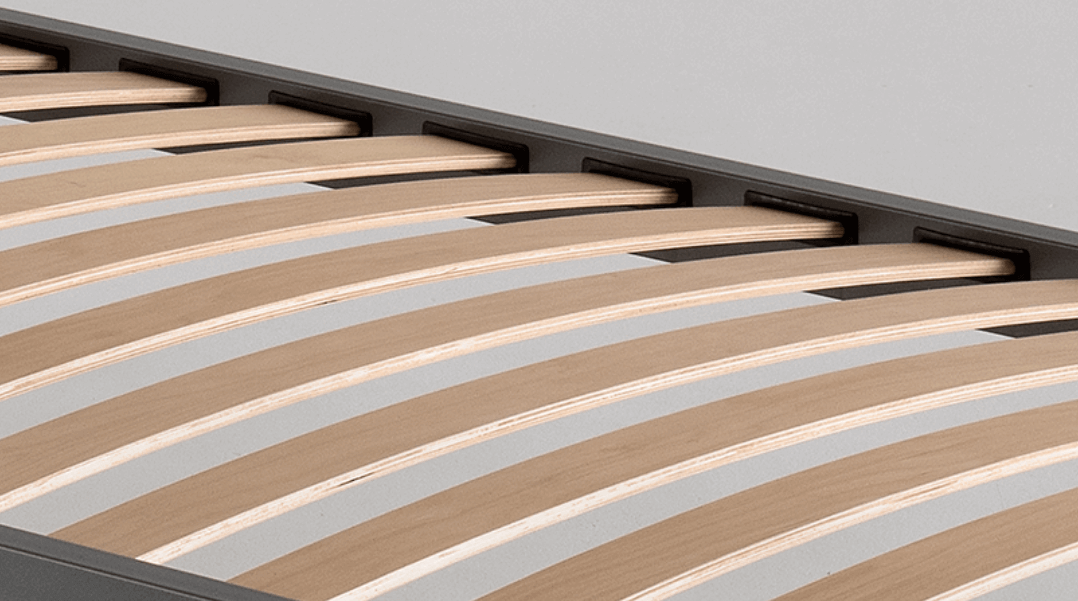 Close-up of a sturdy wooden slatted bed base demonstrating optimal support and durability for a space-saving opklapbed.